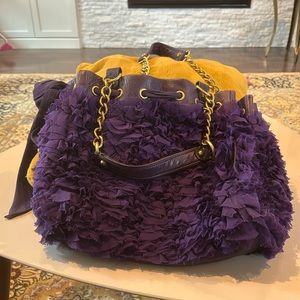 Juicy Couture purple shoulder bag with brass accents.